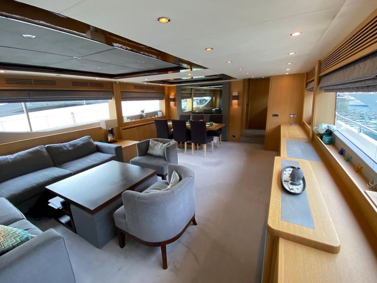 a living room with a couch and a table aboard MOONDANCER Yacht for Sale
