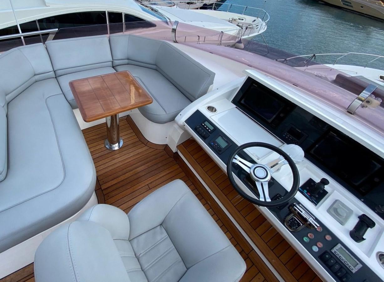a boat with a seat and a steering wheel aboard MOONDANCER Yacht for Sale