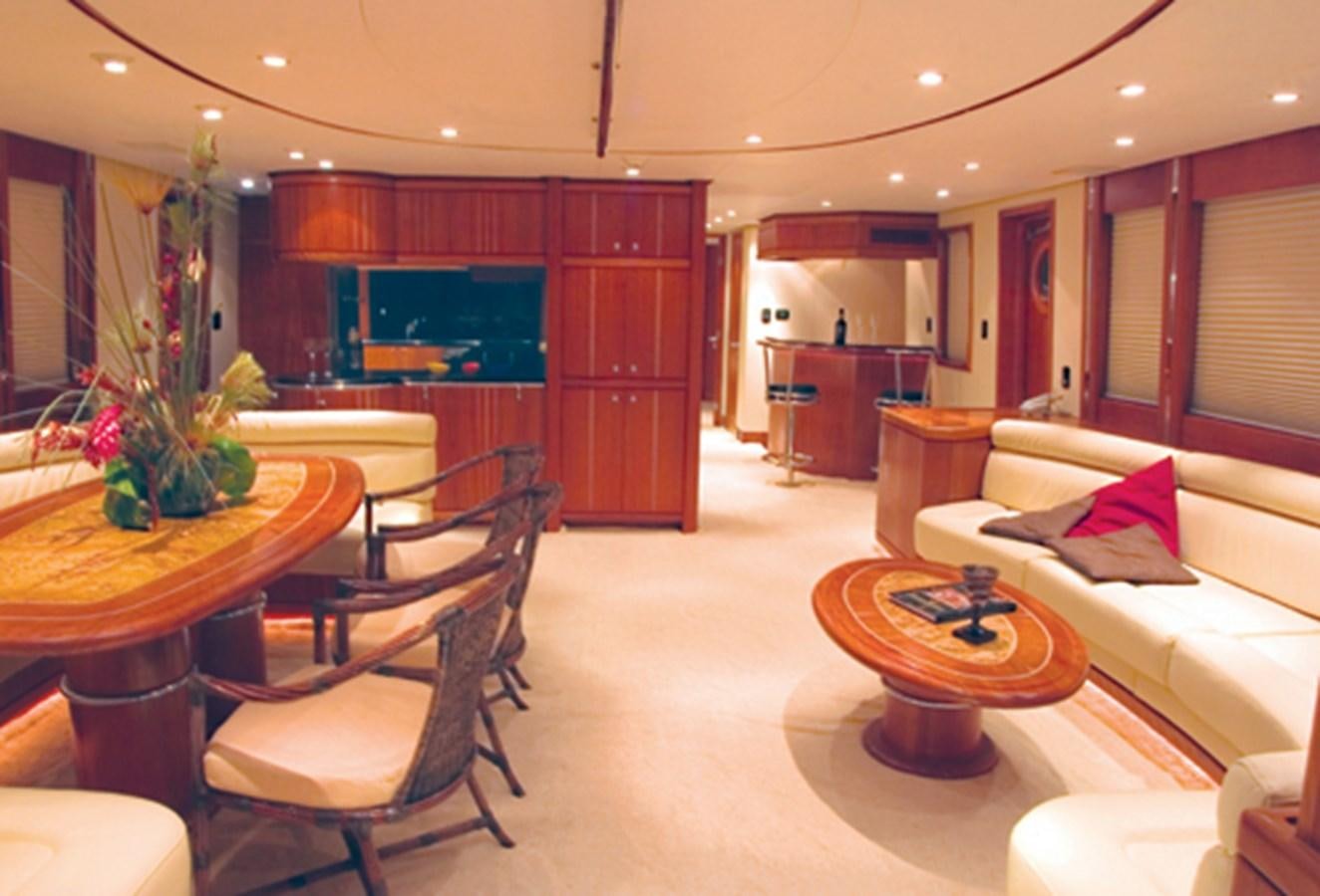 a living room with a table and chairs aboard FORTALEZA 85 SERIES  Yacht for Sale
