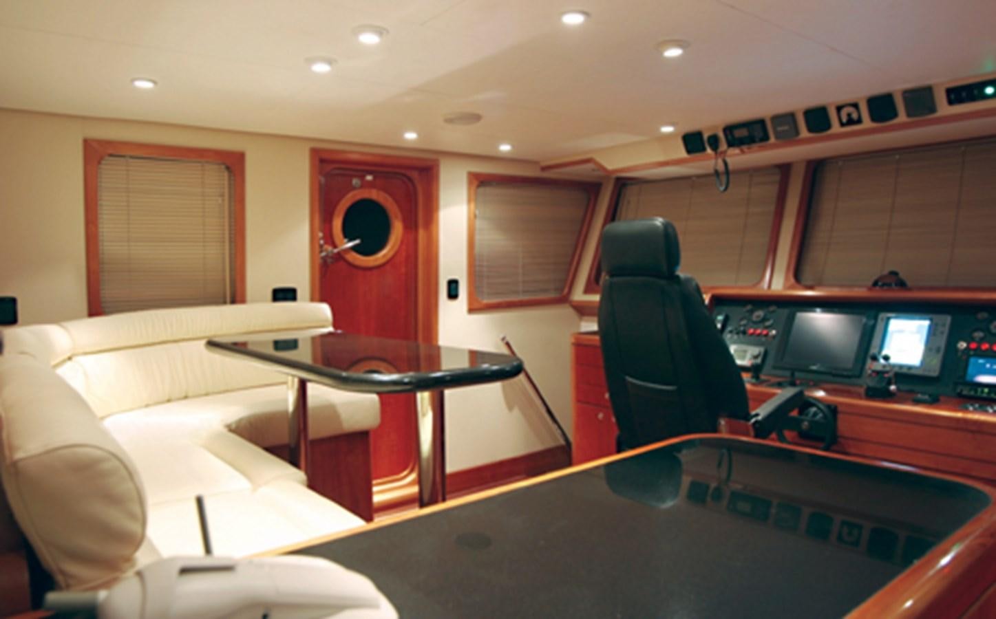 a room with a table and chairs aboard FORTALEZA 85 SERIES  Yacht for Sale