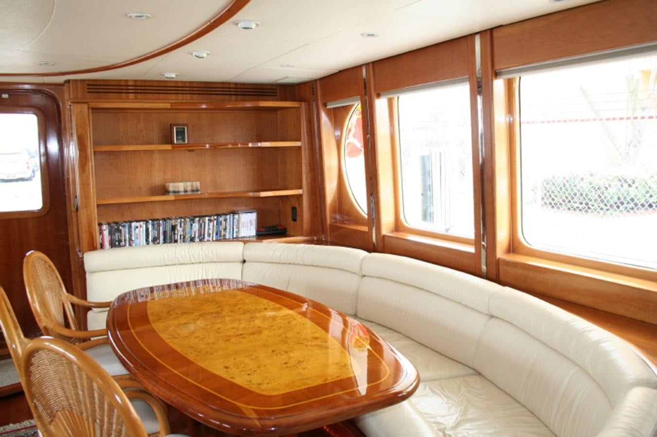 a living room with a bookcase aboard FORTALEZA 85 SERIES  Yacht for Sale