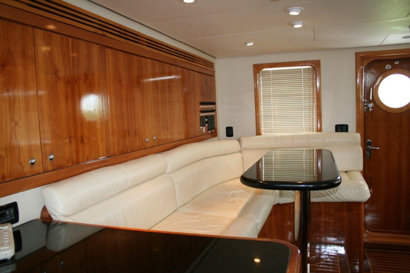 a living room with a couch and a table aboard FORTALEZA 85 SERIES  Yacht for Sale