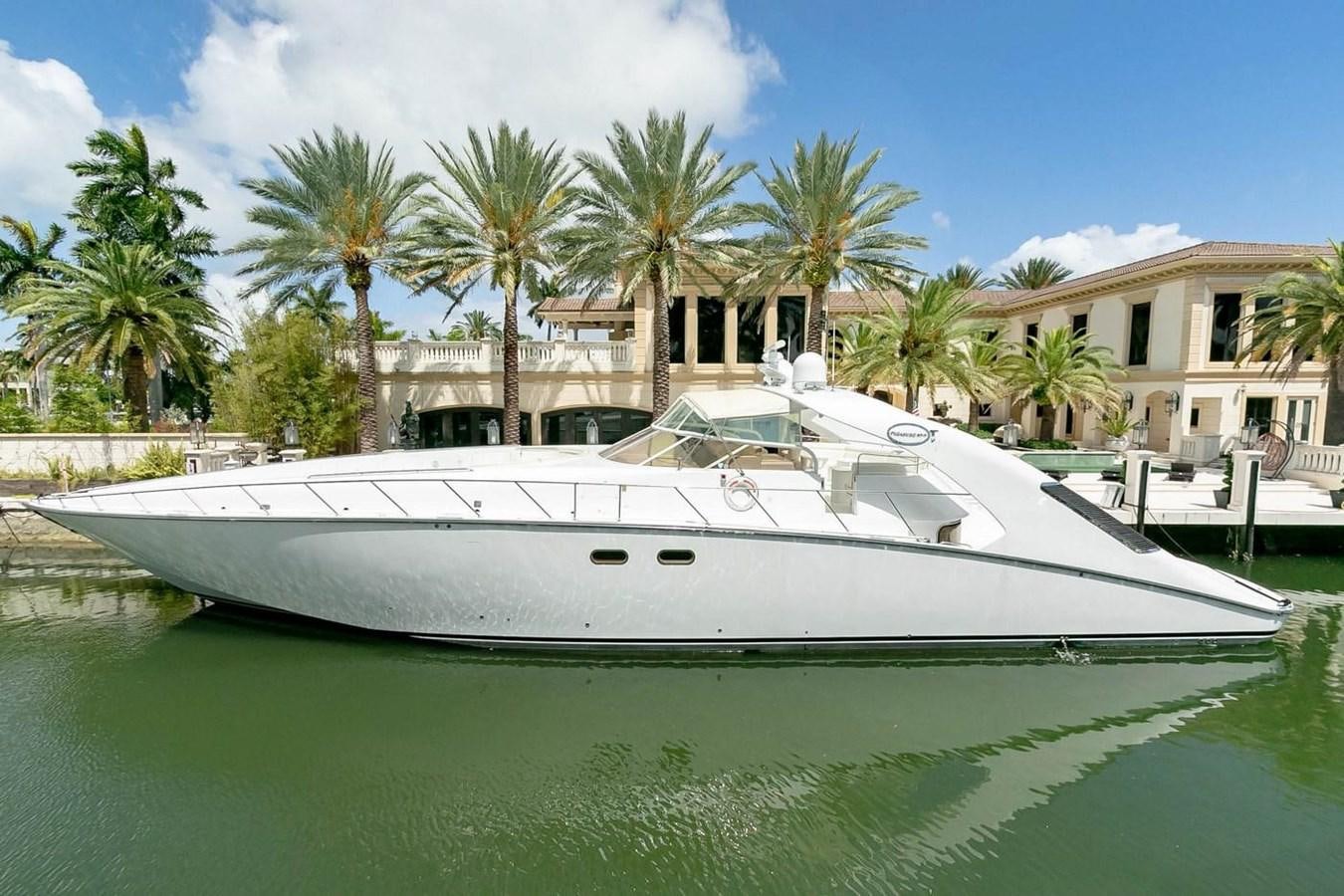 a white boat in a tropical setting aboard PURELY PLEASURE Yacht for Sale