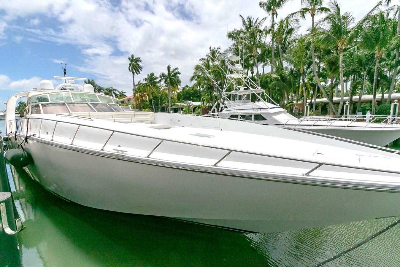 a white boat in a tropical setting aboard PURELY PLEASURE Yacht for Sale