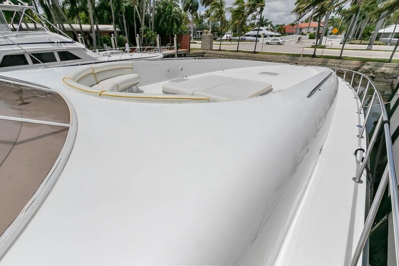 a white boat on a dock aboard PURELY PLEASURE Yacht for Sale