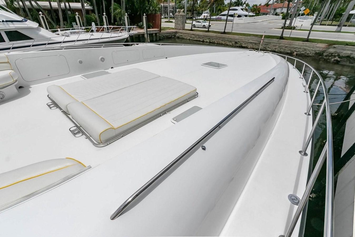 a white boat on a deck aboard PURELY PLEASURE Yacht for Sale