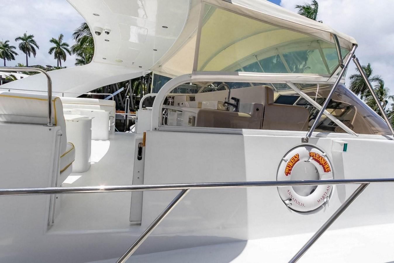 a white car with a logo on it aboard PURELY PLEASURE Yacht for Sale
