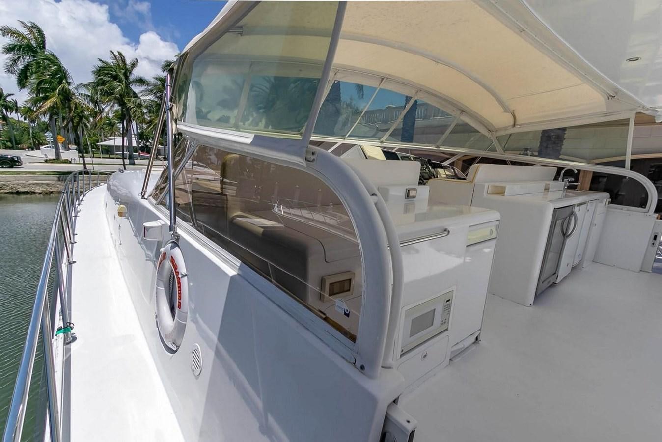 a boat with a large white canopy aboard PURELY PLEASURE Yacht for Sale