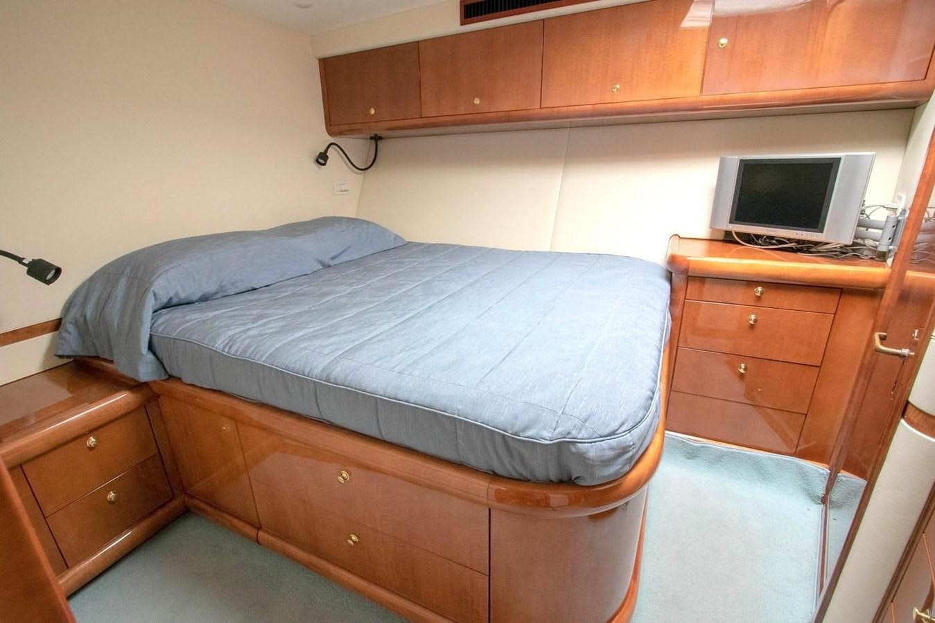 a bed with a desk and a computer aboard PURELY PLEASURE Yacht for Sale