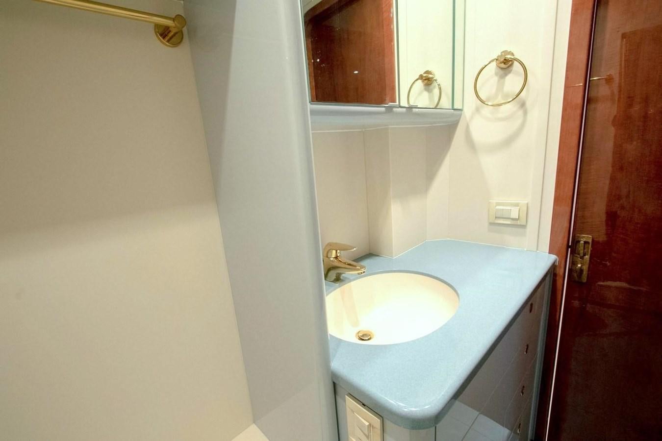 a bathroom with a sink and a mirror aboard PURELY PLEASURE Yacht for Sale