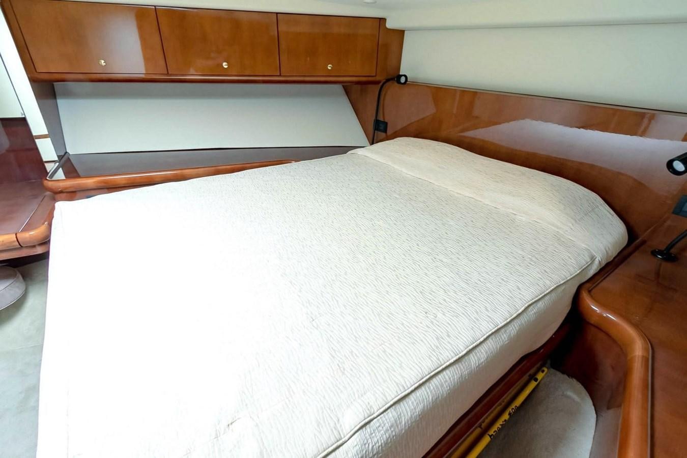 a bed with white sheets aboard PURELY PLEASURE Yacht for Sale