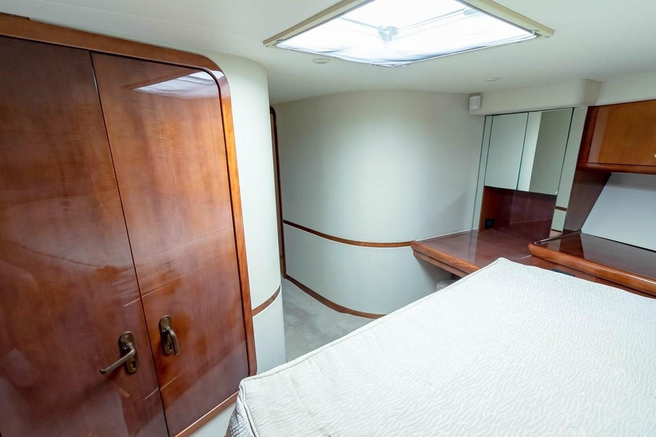 a room with a bed and a closet aboard PURELY PLEASURE Yacht for Sale