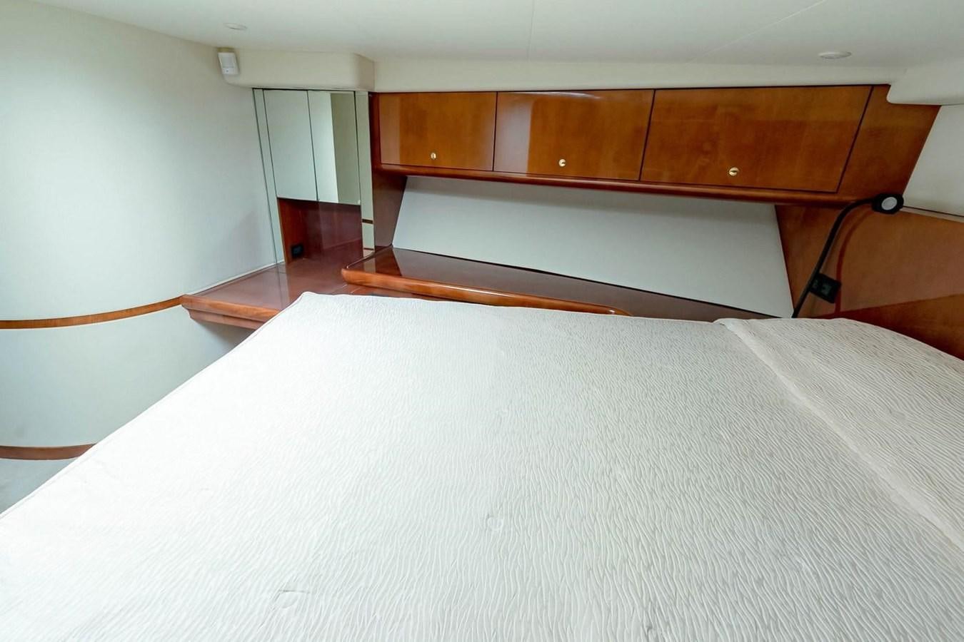 a bed with a white sheet aboard PURELY PLEASURE Yacht for Sale