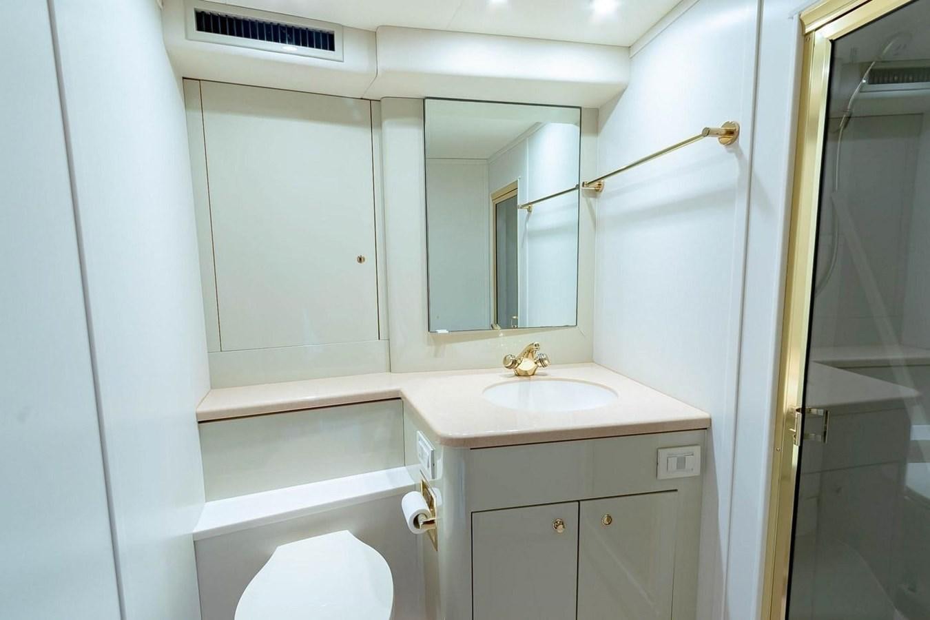 a bathroom with a sink and a mirror aboard PURELY PLEASURE Yacht for Sale