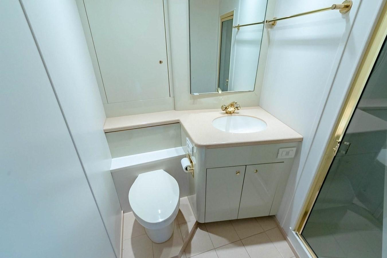 a bathroom with a toilet and sink aboard PURELY PLEASURE Yacht for Sale