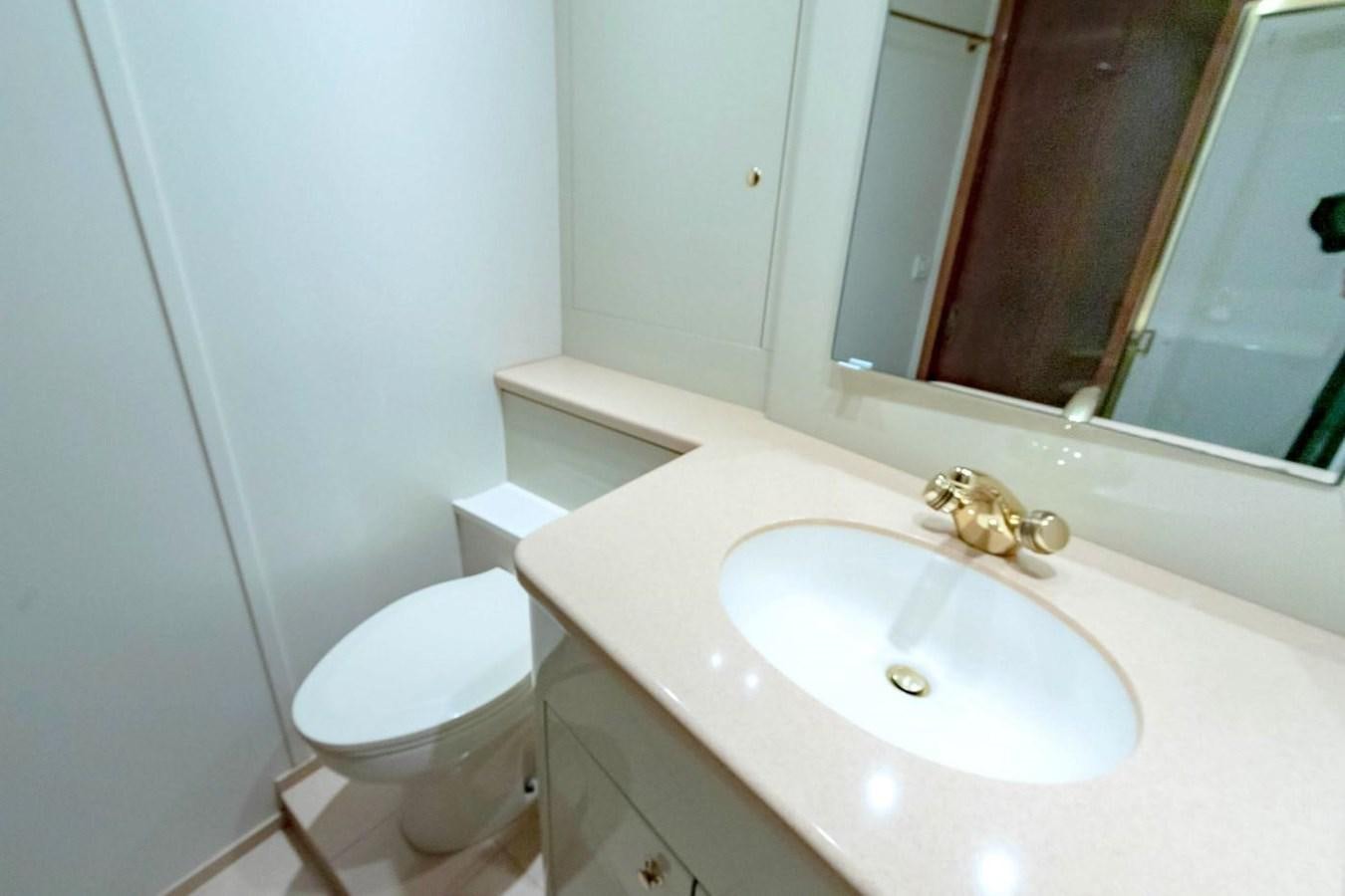 a bathroom with a sink and toilet aboard PURELY PLEASURE Yacht for Sale