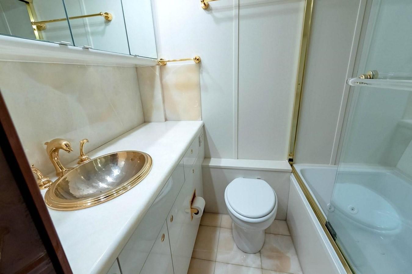 a bathroom with a sink toilet and bathtub aboard PURELY PLEASURE Yacht for Sale