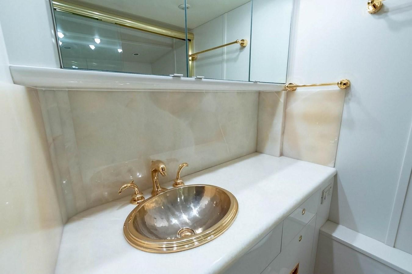 a bathroom with a sink and a mirror aboard PURELY PLEASURE Yacht for Sale