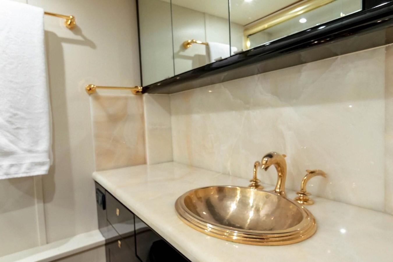 a bathroom with a sink and a mirror aboard PURELY PLEASURE Yacht for Sale