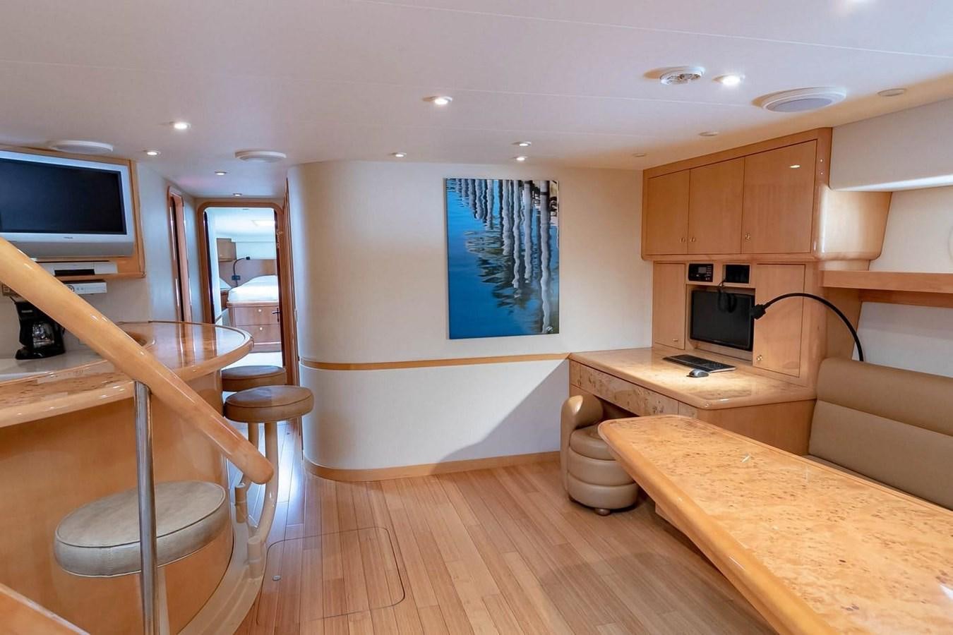 a kitchen with a table and a tv aboard PURELY PLEASURE Yacht for Sale