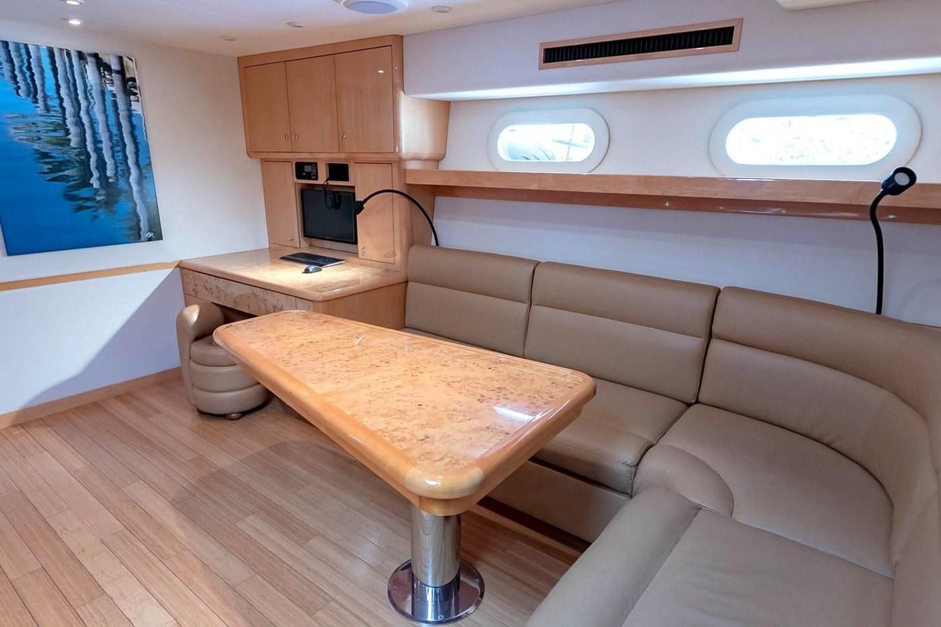 a living room with a table and couch aboard PURELY PLEASURE Yacht for Sale