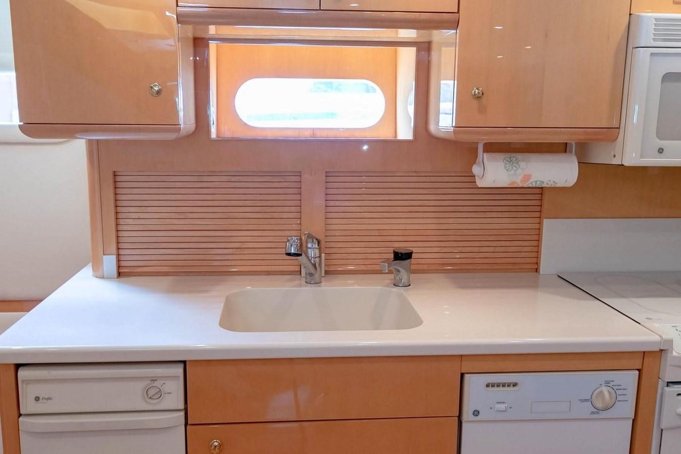 a kitchen with a sink and cabinets aboard PURELY PLEASURE Yacht for Sale
