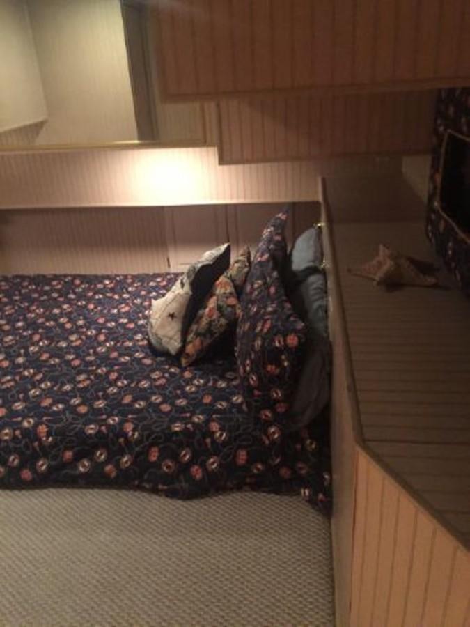a bed with a blue blanket aboard SUMERSET HOUSEBOAT Yacht for Sale