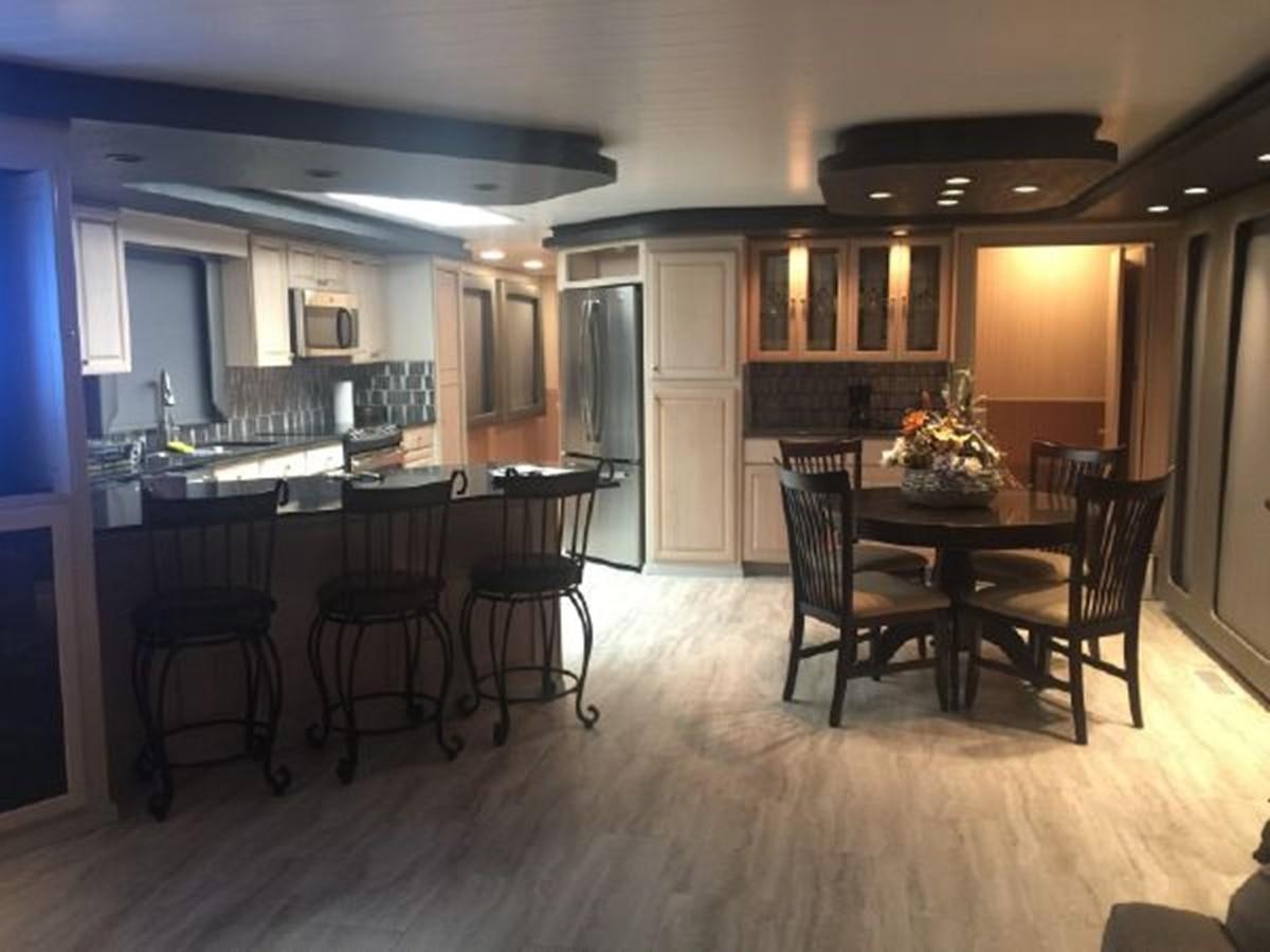 a kitchen with a dining table aboard SUMERSET HOUSEBOAT Yacht for Sale