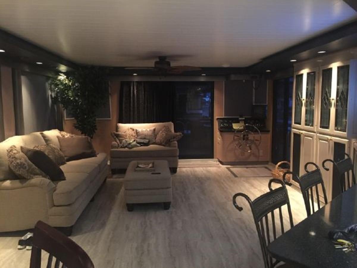 a living room with a couch and a table aboard SUMERSET HOUSEBOAT Yacht for Sale
