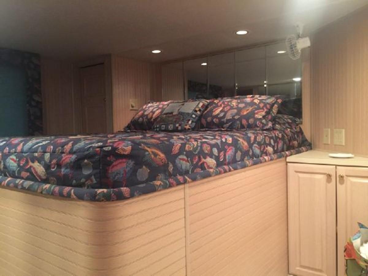 a couch with a colorful pillow aboard SUMERSET HOUSEBOAT Yacht for Sale