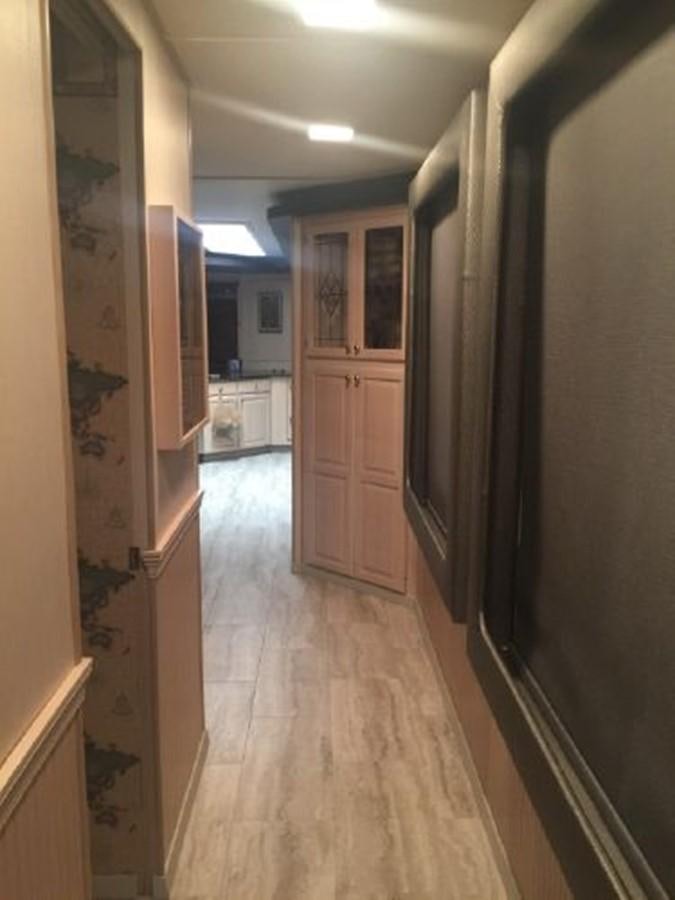a hallway with a door and cabinets aboard SUMERSET HOUSEBOAT Yacht for Sale