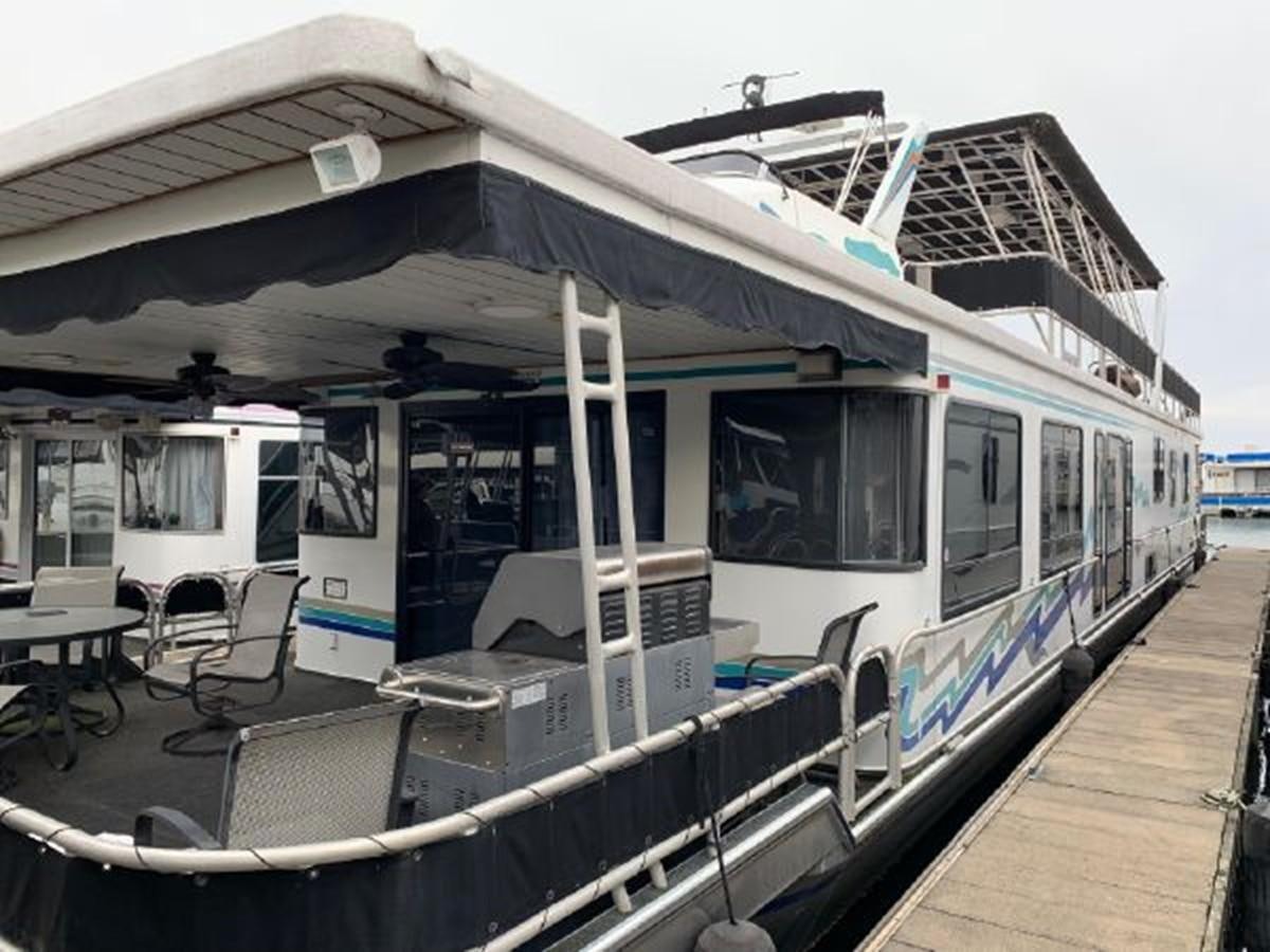 a boat parked at a dock aboard SUMERSET HOUSEBOAT Yacht for Sale