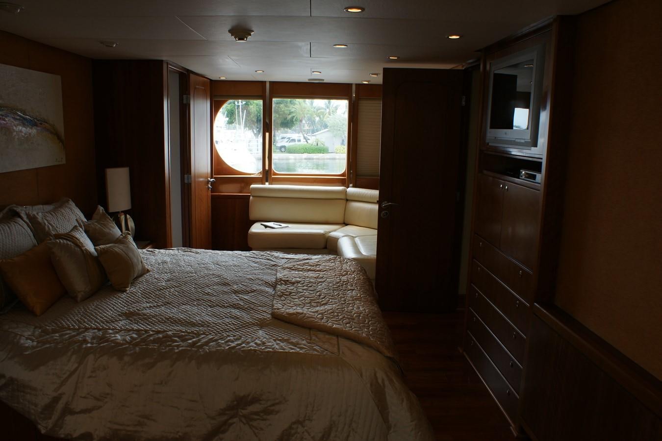 a bedroom with a bed and a couch aboard FORTALEZA Yacht for Sale