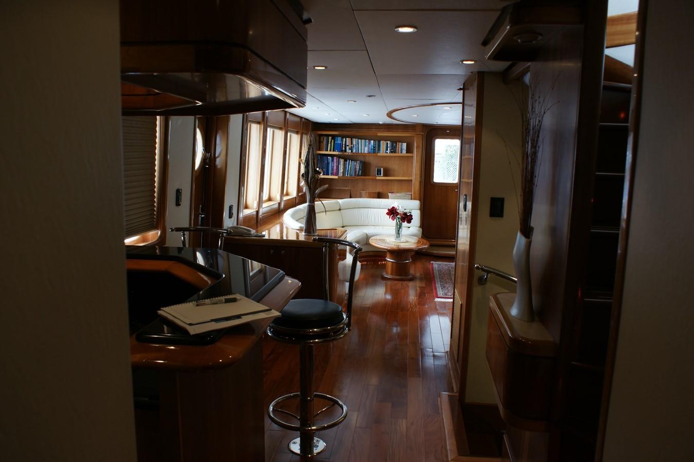 a room with a bed and desk aboard FORTALEZA Yacht for Sale