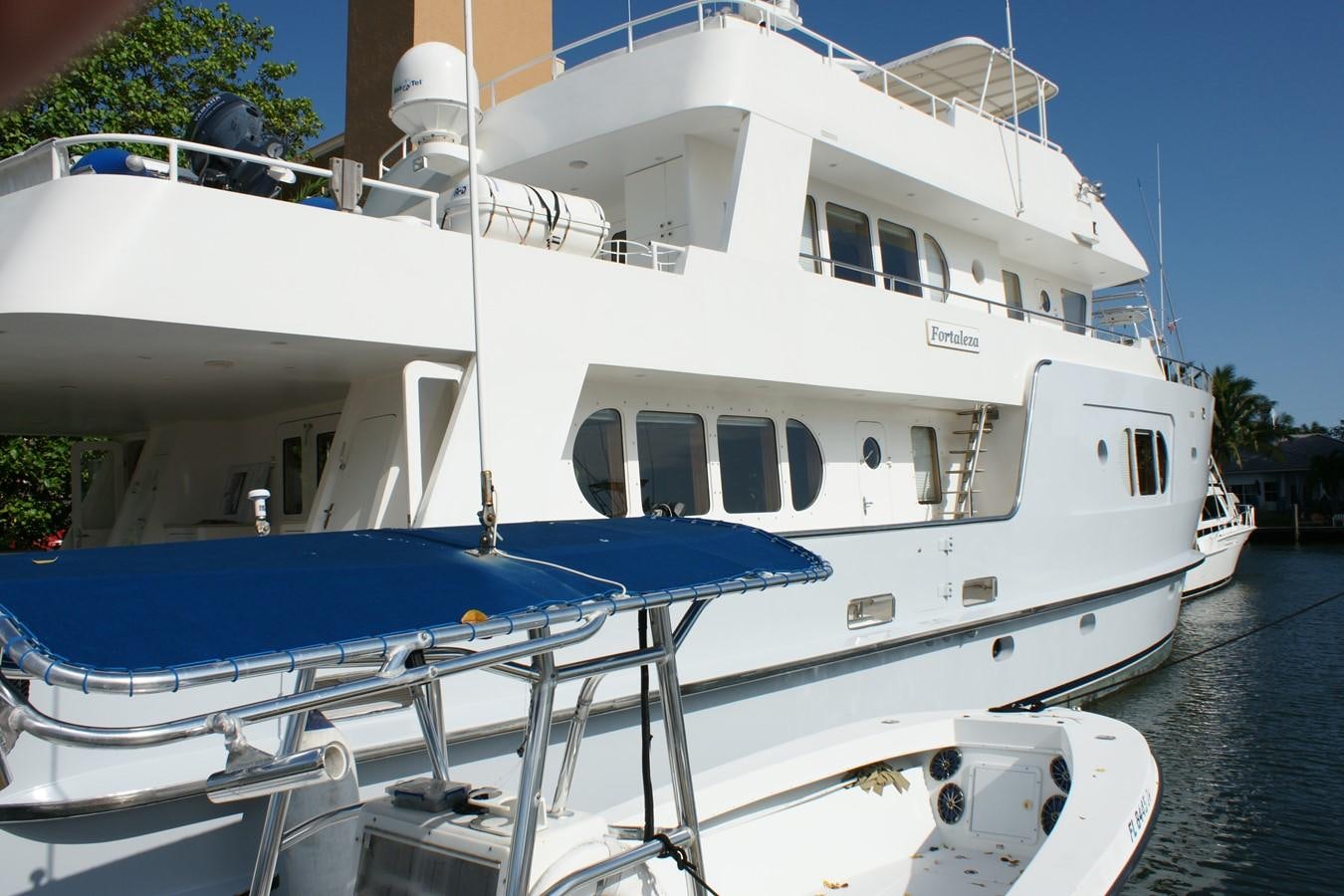 a white boat docked aboard FORTALEZA Yacht for Sale