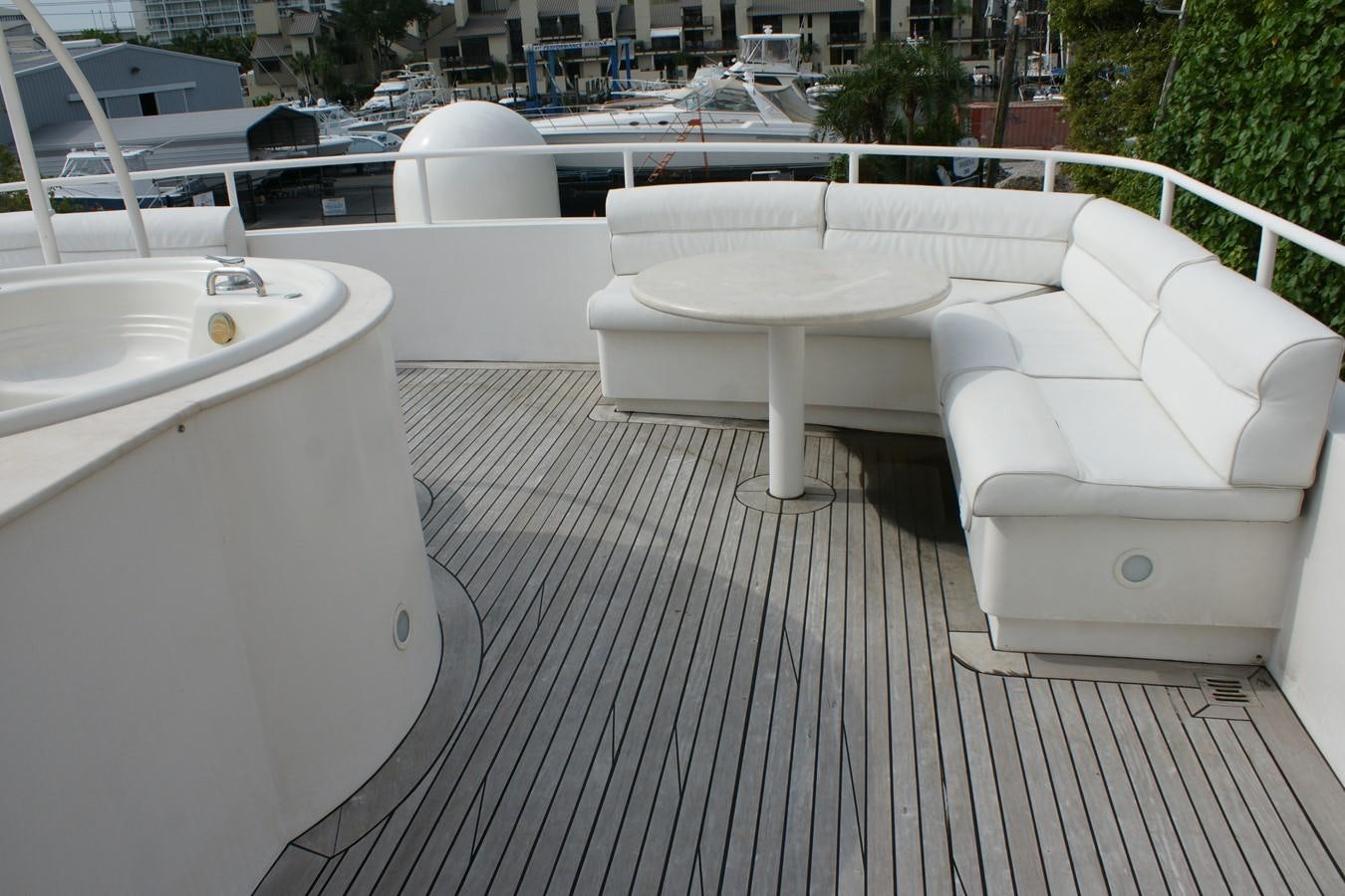 a group of white chairs on a deck next to a body of water aboard FORTALEZA Yacht for Sale