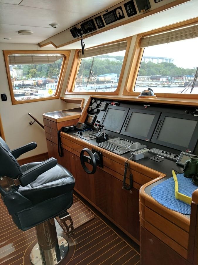a desk with computers and chairs aboard FORTALEZA Yacht for Sale