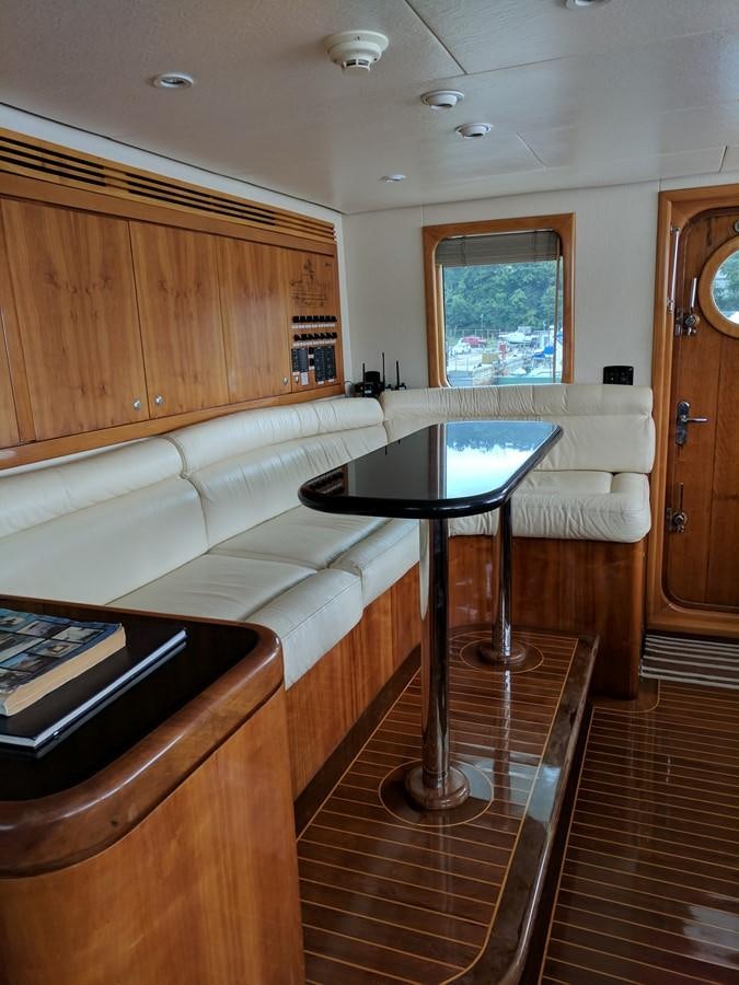 a living room with a couch and a table aboard FORTALEZA Yacht for Sale