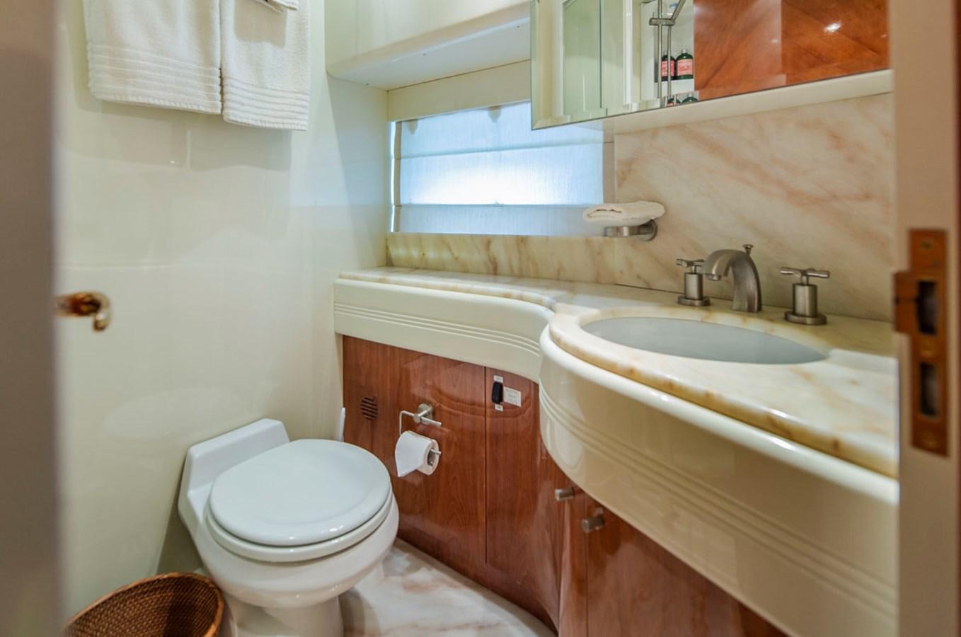 a bathroom with a toilet sink and a mirror aboard SEA HAWK Yacht for Sale