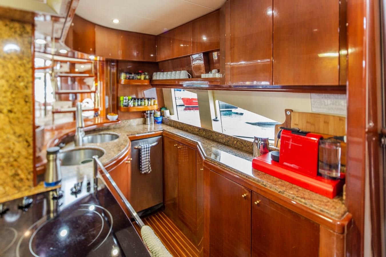 a kitchen with wooden cabinets aboard SEA HAWK Yacht for Sale