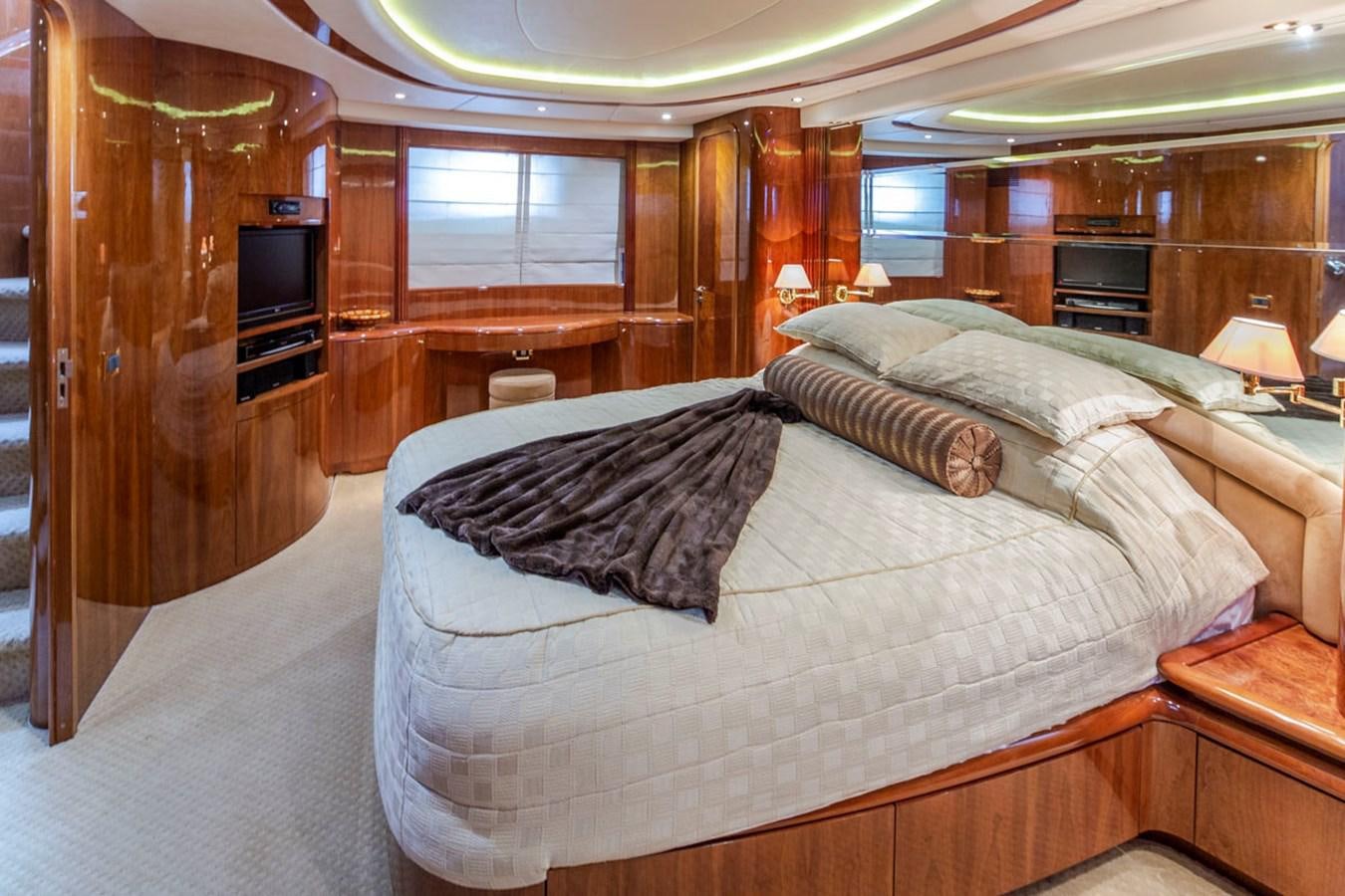a bedroom with a bed and a wood cabinet aboard SEA HAWK Yacht for Sale