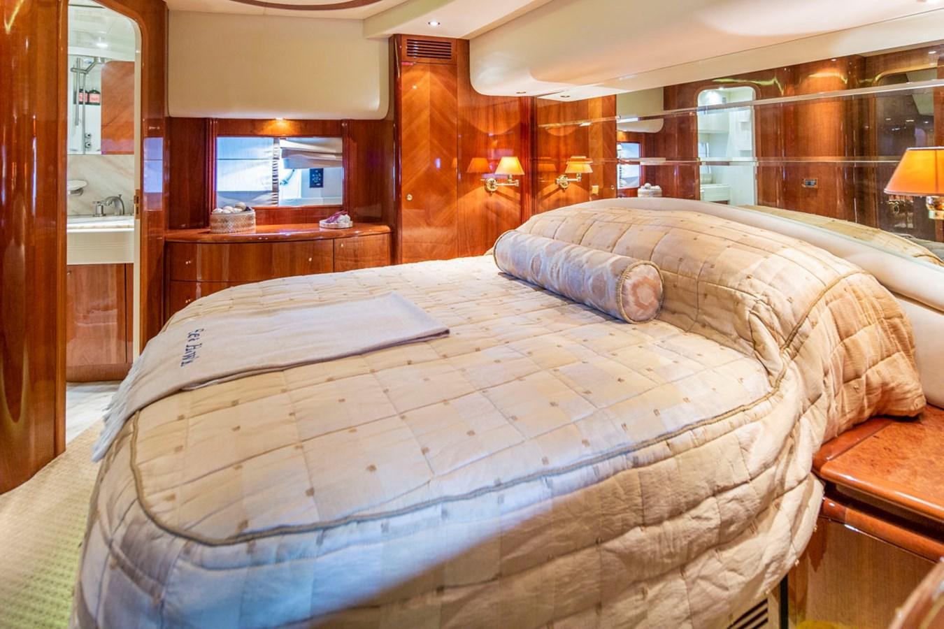 a bed with a white comforter aboard SEA HAWK Yacht for Sale