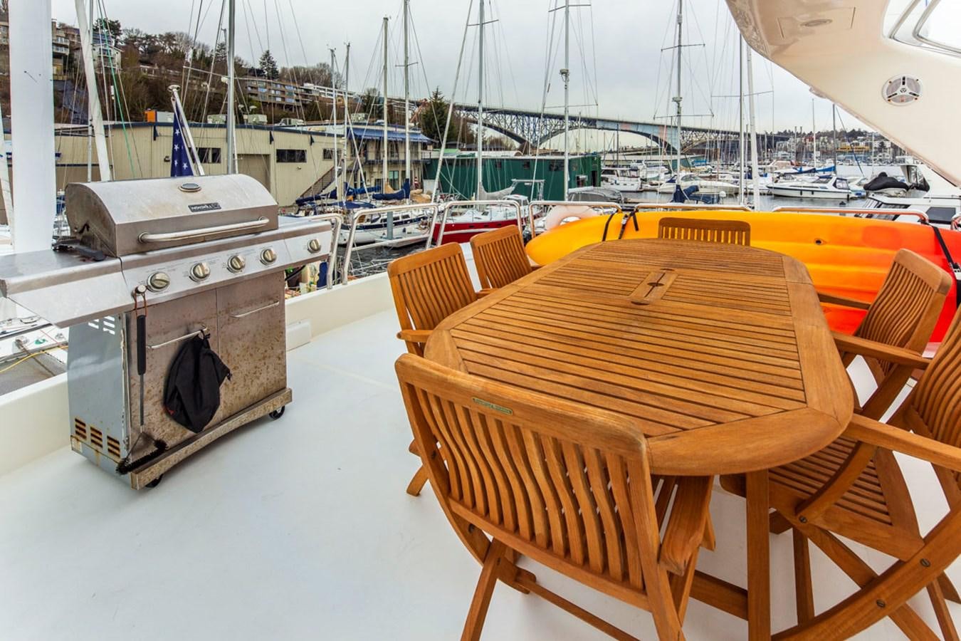 a wooden table and chairs on a boat aboard SEA HAWK Yacht for Sale