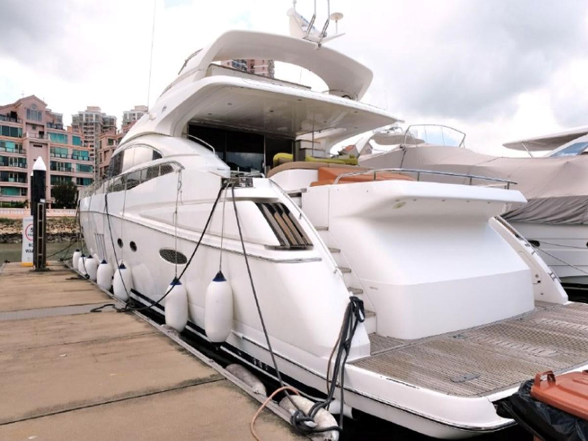 a white boat on a dock aboard PRINCESS V85 Yacht for Sale