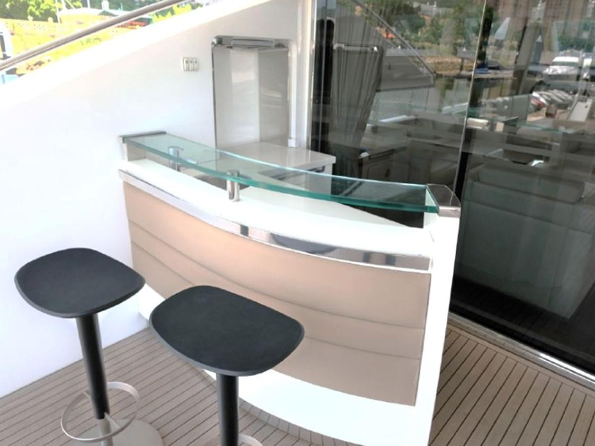 a table with a stool next to it aboard PRINCESS V85 Yacht for Sale