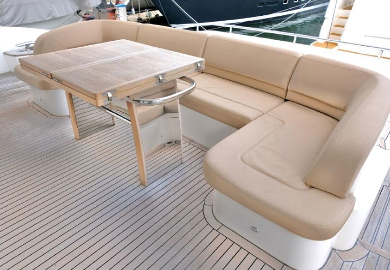 a couch with a table on it aboard PRINCESS V85 Yacht for Sale