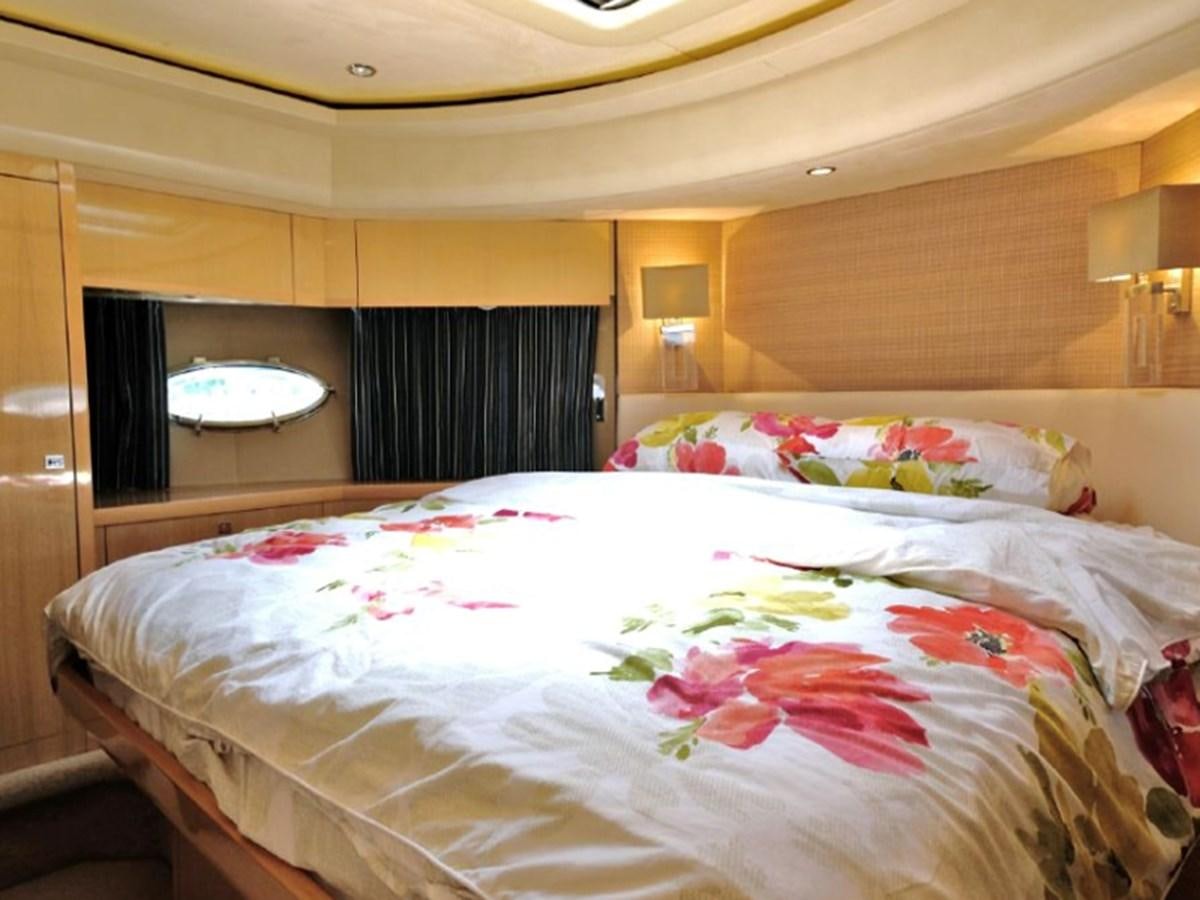 a bedroom with a bed and a mirror aboard PRINCESS V85 Yacht for Sale