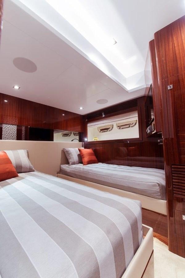 a bedroom with a bed and a wood cabinet aboard E84 (NEW BOAT SPEC)  Yacht for Sale
