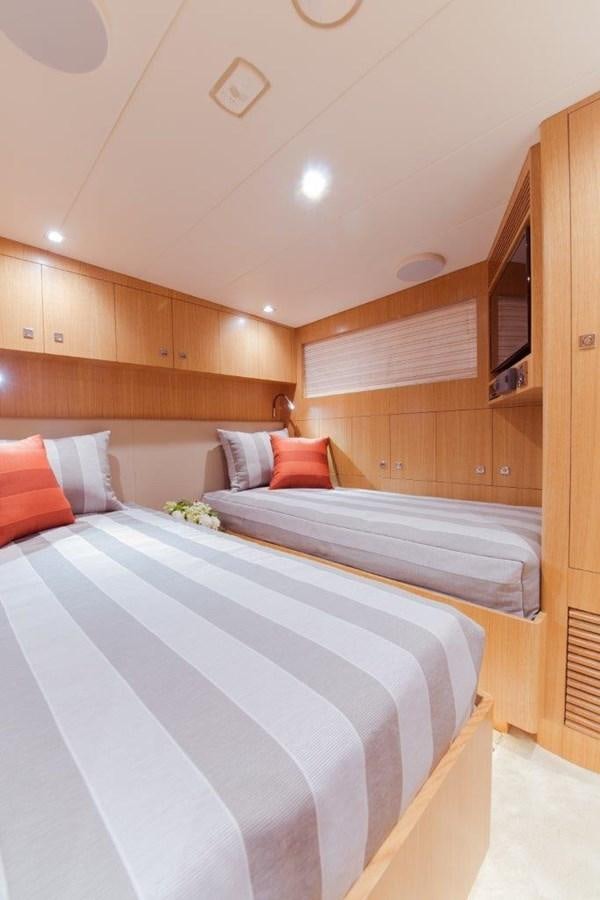 a room with a bed and a wood cabinet aboard E84 (NEW BOAT SPEC)  Yacht for Sale