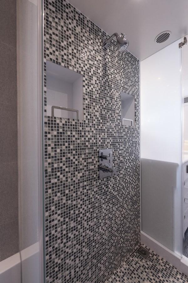a shower with a tile wall aboard E84 (NEW BOAT SPEC)  Yacht for Sale